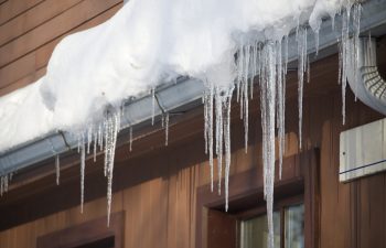 Icicles forming around the gutters of a house